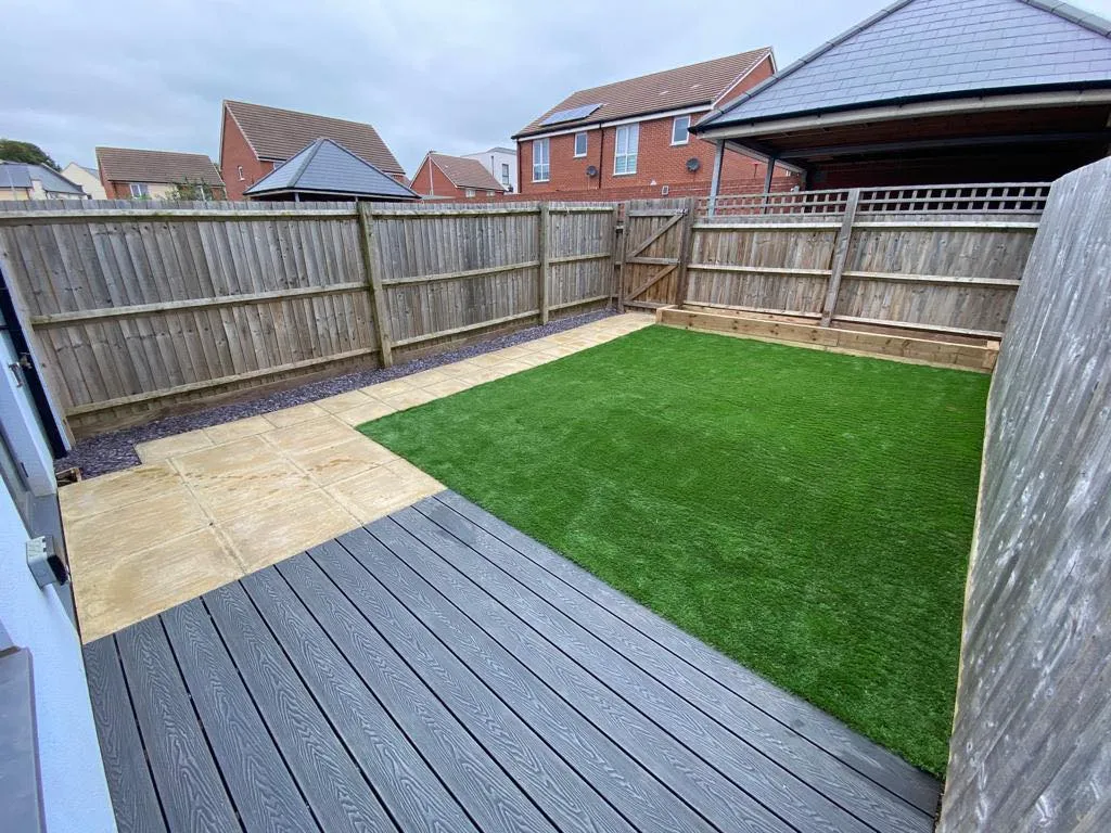a new grey patio with a sandstone path