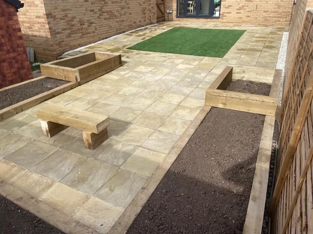 long patio with grass and white tiles